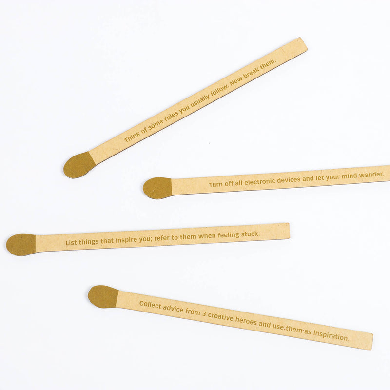 Four wooden sticks with engraved text on a white background