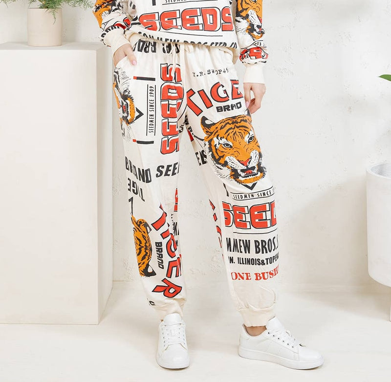 Person wearing a white outfit with tiger and text design, standing against a white background.