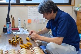 Person working on small items in a workshop setting