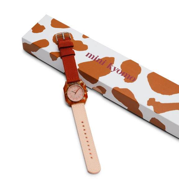 Watch with a cow print strap on a white background