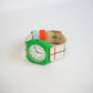 Colorful watch with a green case and multicolored strap on a white background