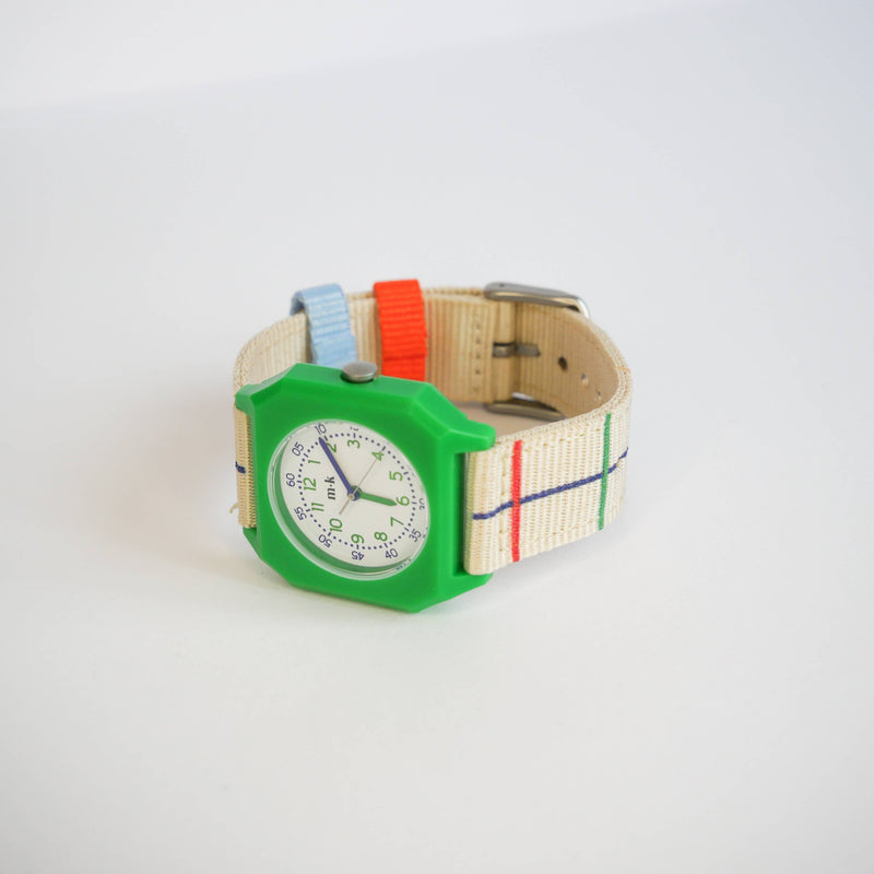 Colorful watch with a green case and multicolored strap on a white background