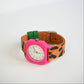 Colorful watch with a pink case and brown strap on a white background