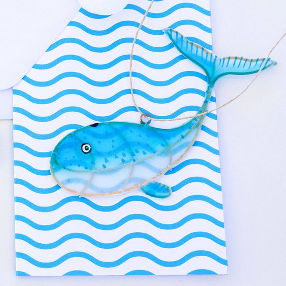 Blue fish on a white and blue striped towel with a white background
