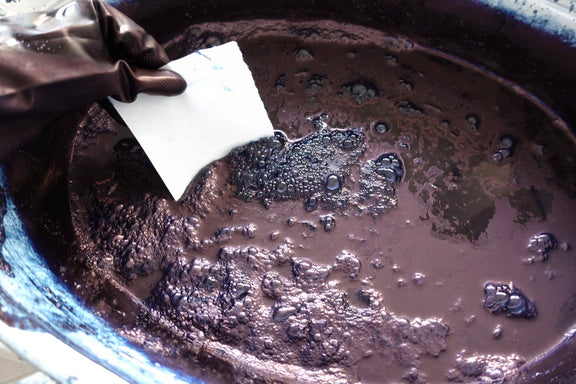 Chocolate mixture being stirred in a bowl with a spatula