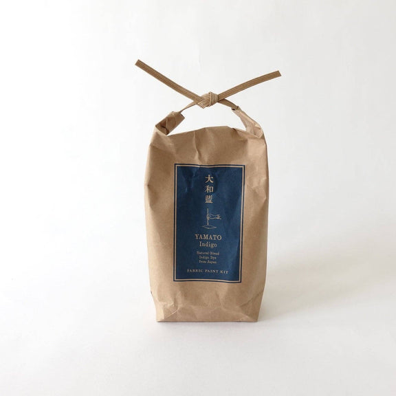 Kraft paper bag with a blue label on a white background