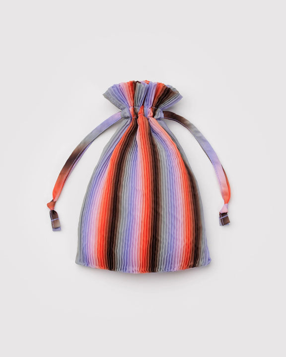 Multicolored striped drawstring bag on a light gray background