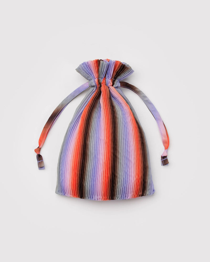 Multicolored striped drawstring bag on a light gray background