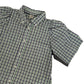Close up of a remade Green and black checkered shirt with 'The Cut' branding on a white background