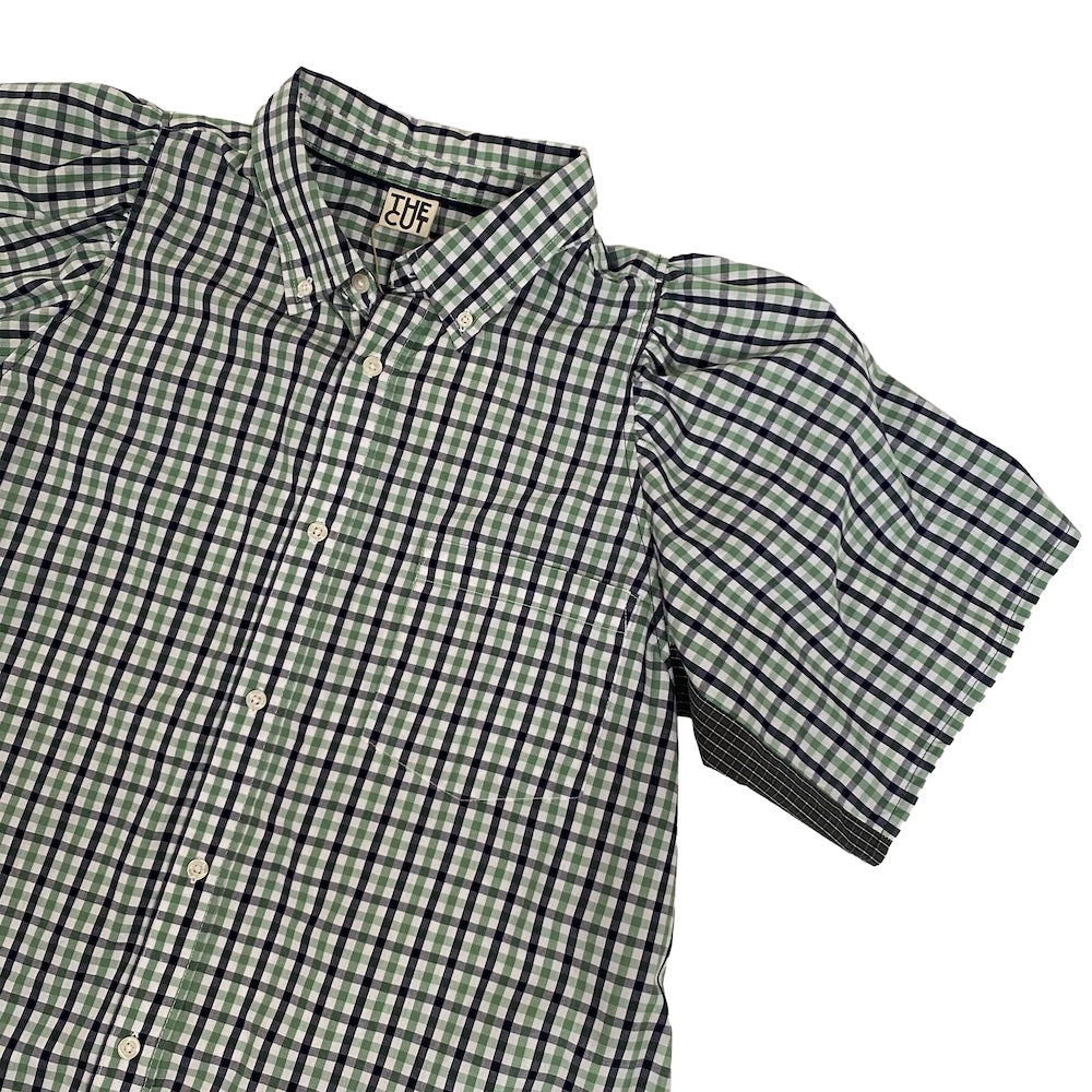 Close up of a remade Green and black checkered shirt with 'The Cut' branding on a white background