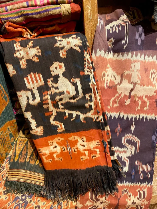 Traditional woven textiles with intricate patterns on a wooden surface