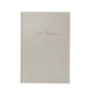 Beige textured book with 'Jim Harrison' inscription on a white background