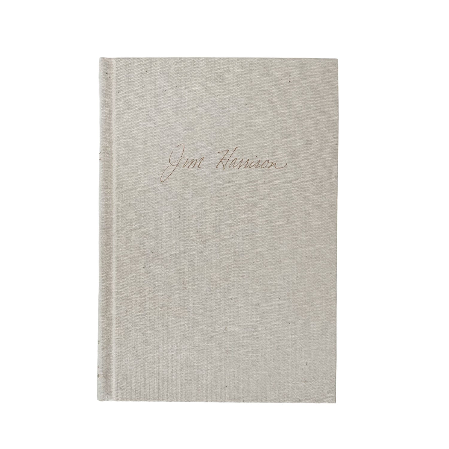 Beige textured book with 'Jim Harrison' inscription on a white background