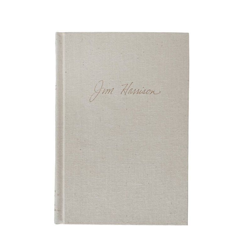 Beige textured book with 'Jim Harrison' inscription on a white background