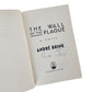 Open book with 'The Wall of the Plague' Signed by André Brink on a white background