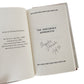 Open book with 'The Sorcerer's Apprentice' title and signature on a white background