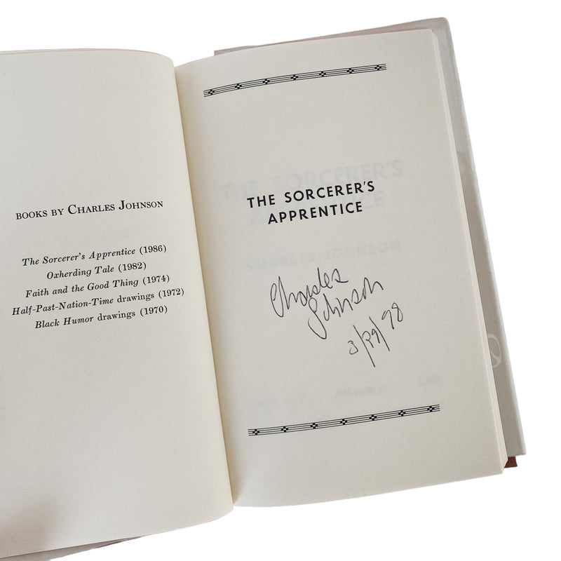 Open book with 'The Sorcerer's Apprentice' title and signature on a white background