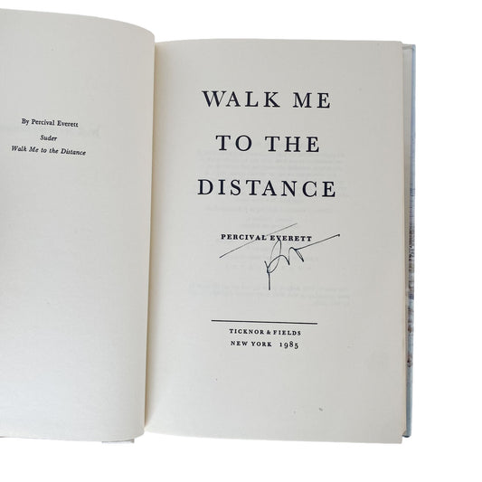 Open book with title 'Walk Me to the Distance' signed by Percival Everett on a white background