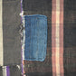 Vintage Japanese boro with vertical line pattern and indigo colored patchwork, close up