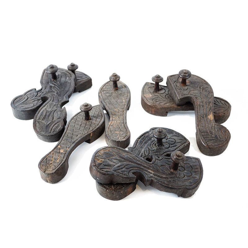 Four pairs of wood carved in a shoe shape with hand carved designs